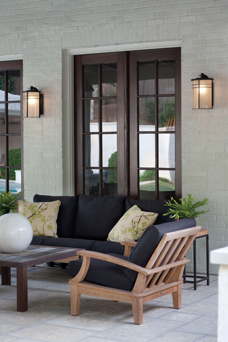 Modern Hinkley sconce lighting on outdoor back patio wall