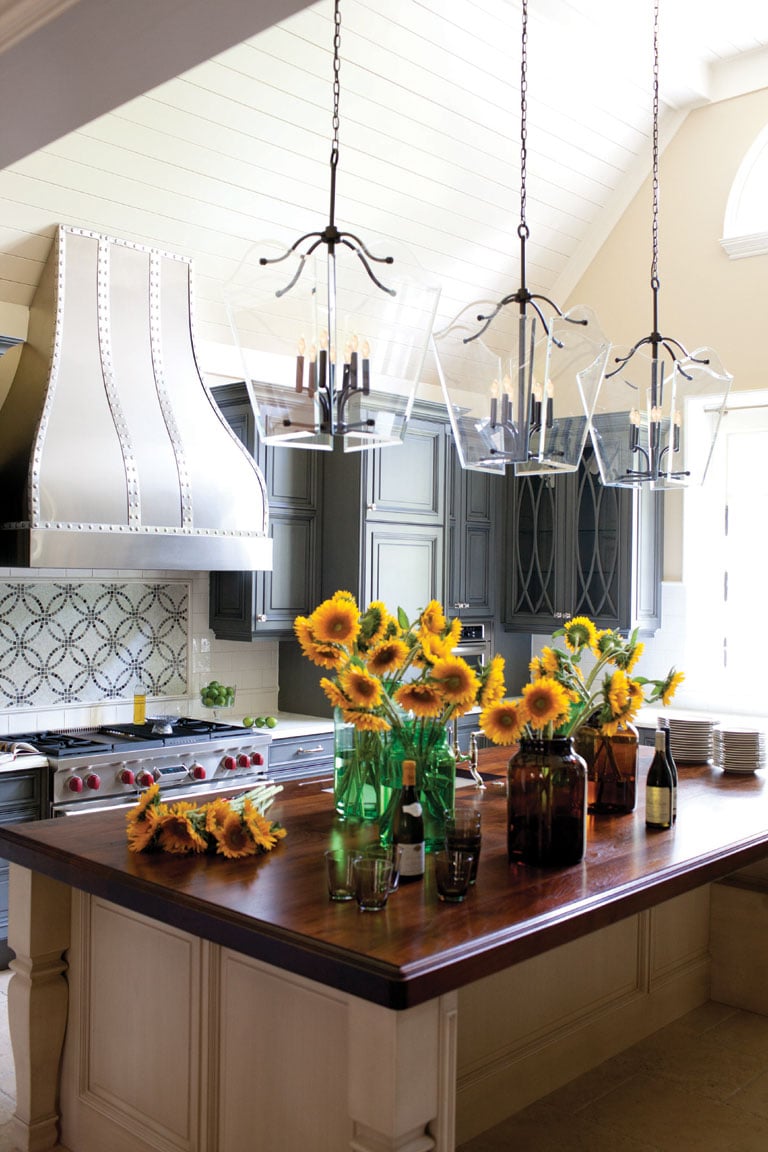Multiple Glass Chandeliers with Candles Over Kitchen Island
